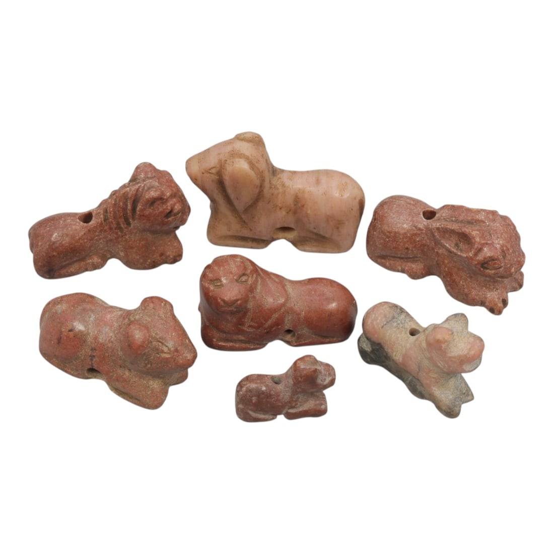 Lot of 7 Ancient Bactrian Zoomorphic Stone Amulets, Circa 3rd-2nd Millennium BCE, 54WT: Carved from reddish, pinkish, and mottled stone varieties, the group consists of seven stylized zoomorphic amulets. Each piece is rendered in a reclining or seated form with simplified anatomical feat