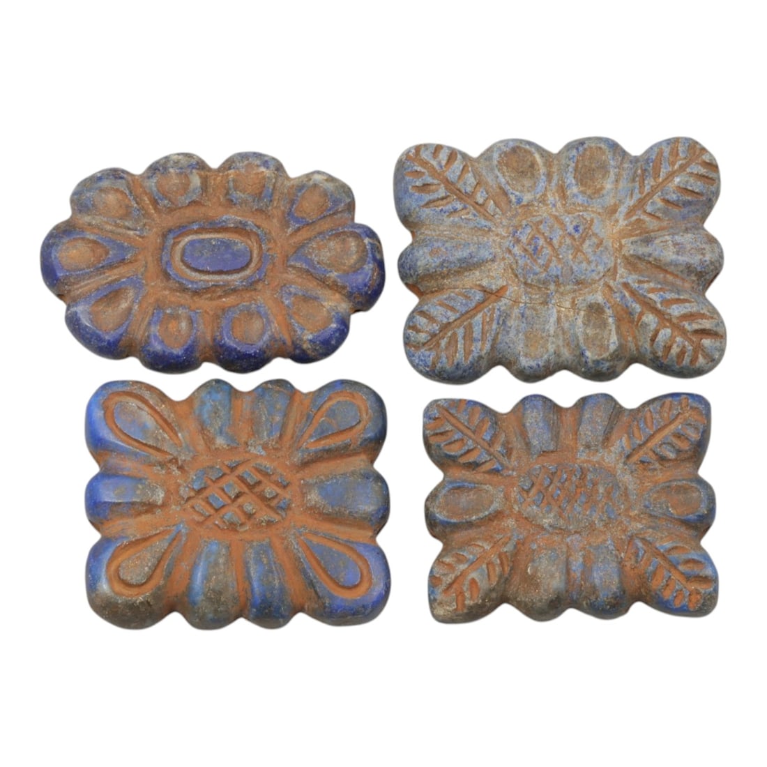 Lot of 4 Ancient Achaemenid Lapis Lazuli Floral Beads, Circa 5th-4th Century BCE, 30WT: Carved from lapis lazuli, the group consists of four flat, flower-shaped beads. Each piece features a floral motif with incised petals radiating from a central design, including cross-hatching, ovals,