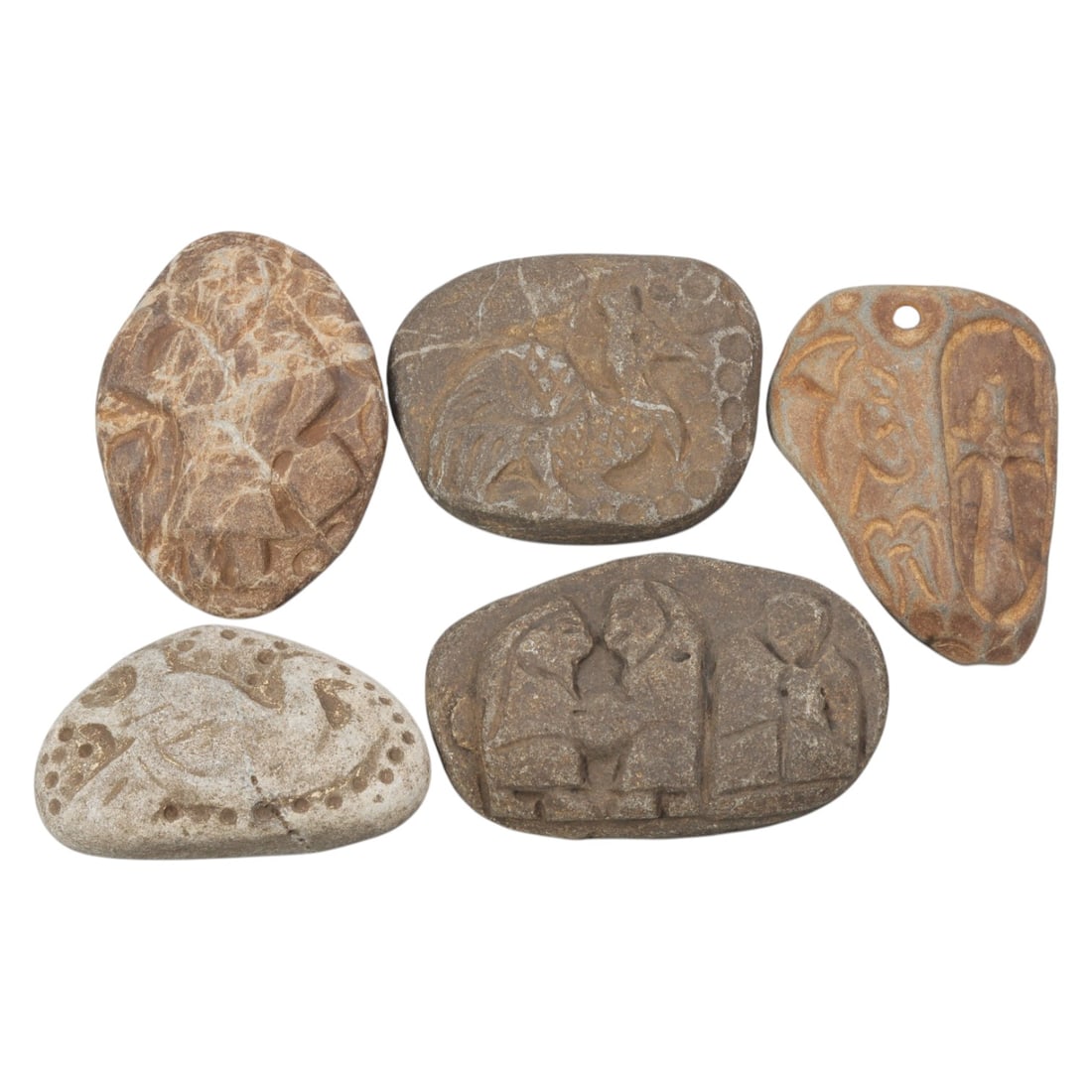 Lot of 5 Ancient Christian Stone Amulet Plaques, 21WT: Five carved stone plaques, each worked from naturally weathered pebbles of varying brown and grey tones, depicting Christian and medieval motifs. The group includes representations of figures in devot