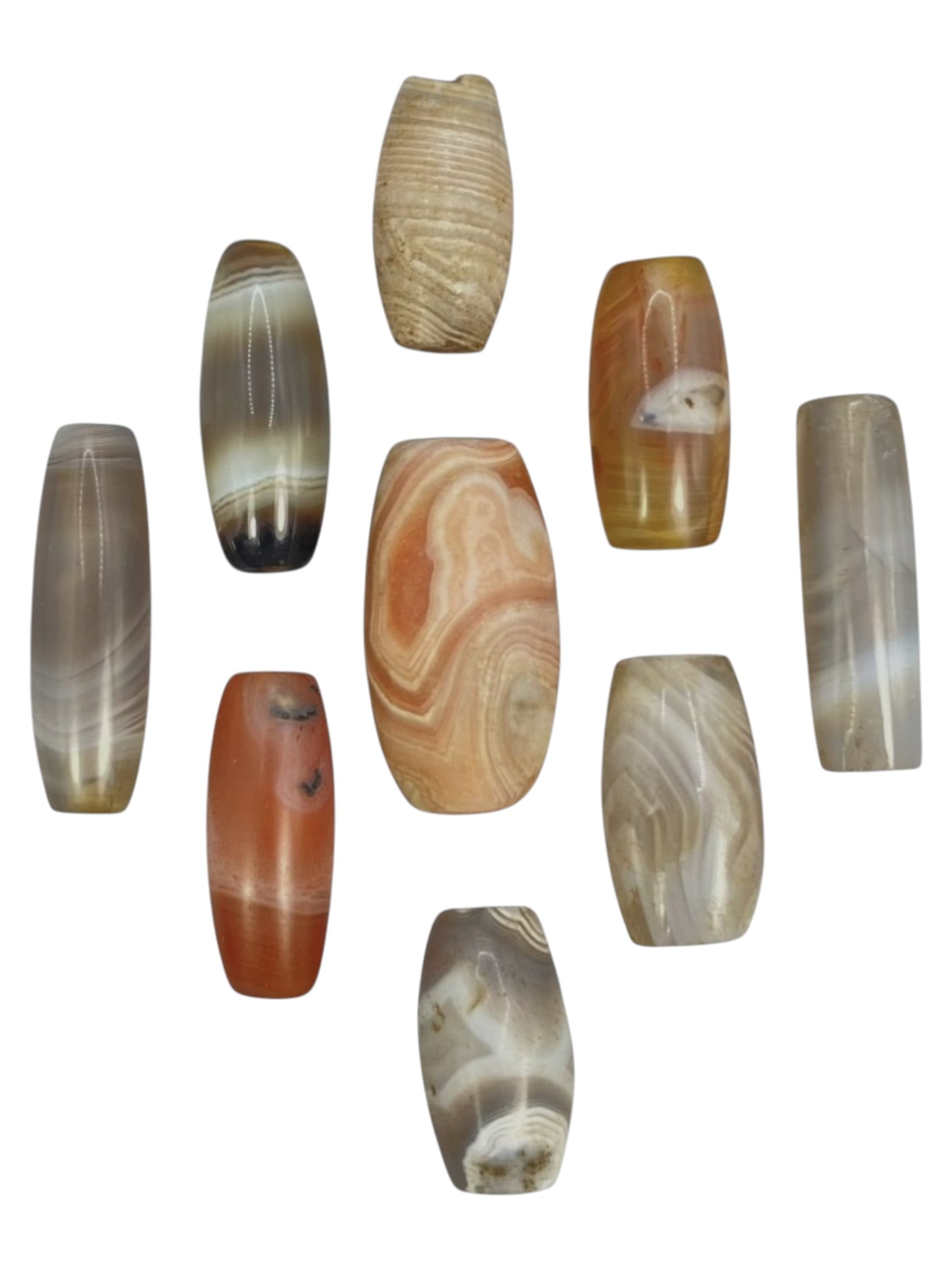 Lot of 9 Himalayan Banded Agate Beads, Ancient to Antique Period, 45WT: A group of nine beads crafted from banded agate, exhibiting a rich spectrum of natural hues including translucent grey, amber, reddish-orange, and multi-tonal striations, with characteristic concentri
