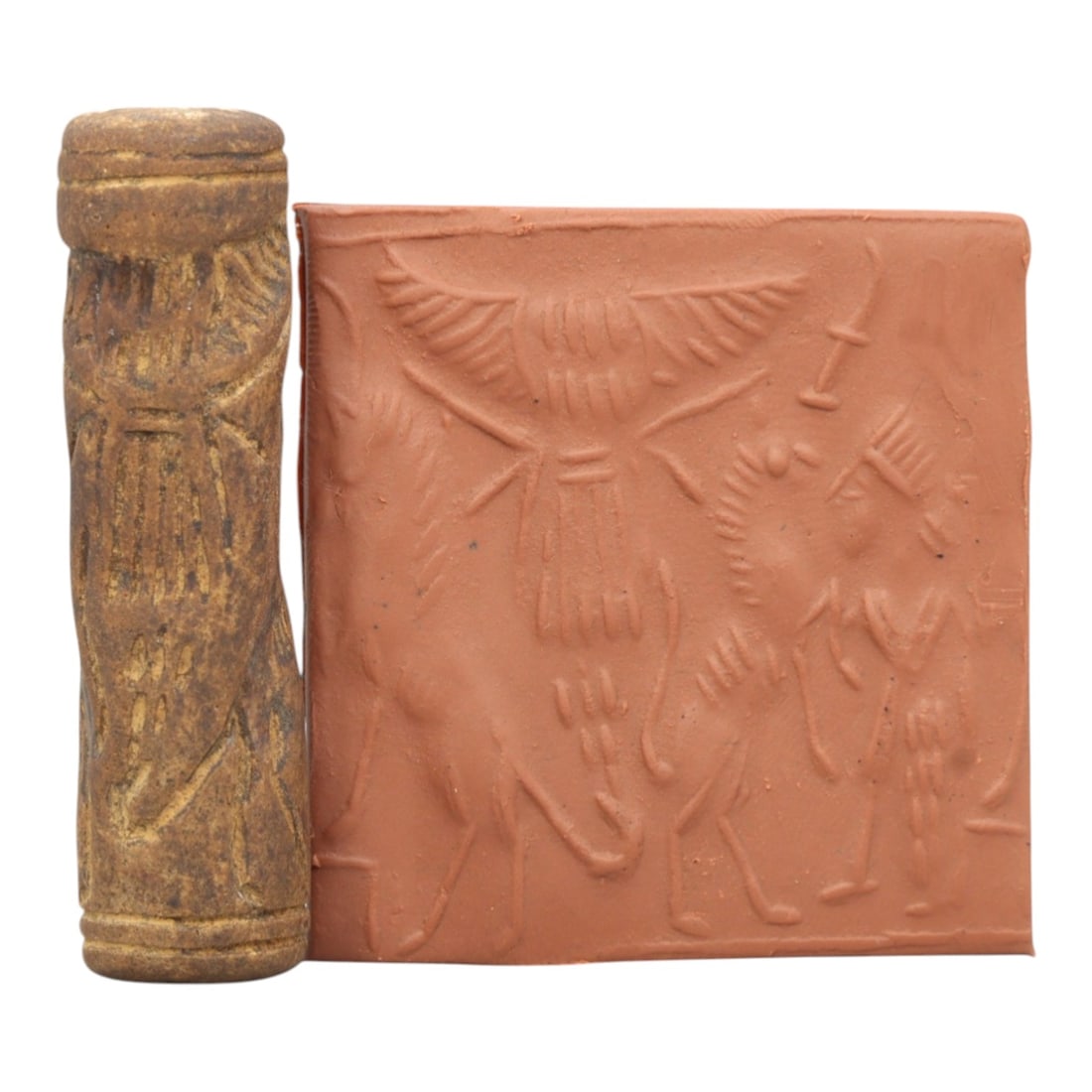 Ancient Steatite Cylinder Seal - Mesopotamian Winged Deity Scene, 94ZR: Carved from dense steatite, this ancient Mesopotamian cylinder seal features a detailed relief composition centered on a prominent winged deity, flanked by animal and human figures in a ritual narrati