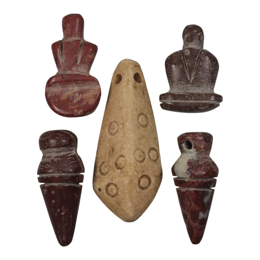 Lot of 5 Ancient Coptic Egyptian Stone Amulets, Circa Roman to Coptic Era, 90WP: Carved from various stones, including reddish-brown and light beige varieties, the group consists of five distinct amulets. The set includes two stylized seated figure pendants, a central teardrop-sha