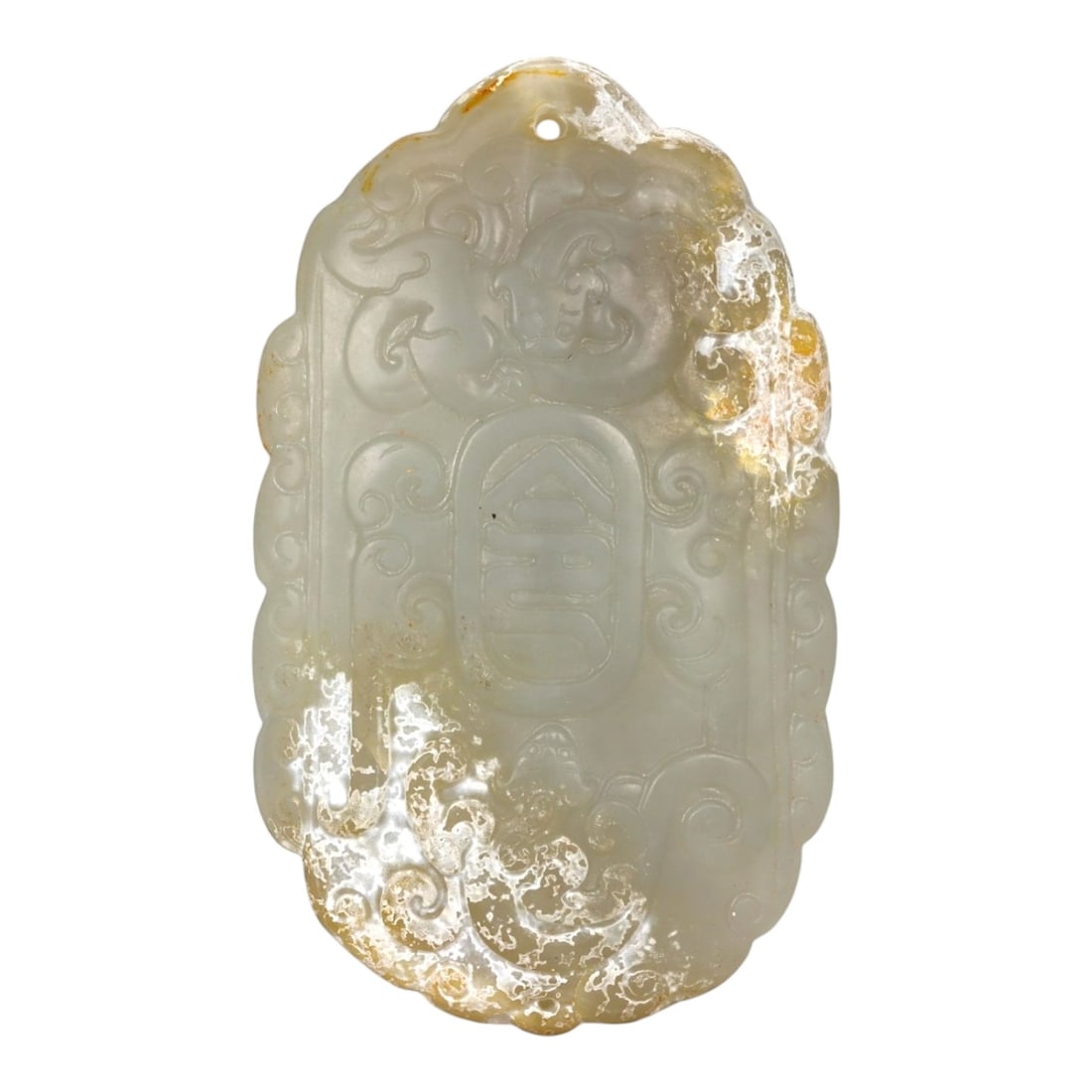 A Chinese Jade Longevity Plaque, Qing Dynasty, 18th-19th Century, 26FA: Carved from pale celadon jade with areas of translucent milky tone and natural russet-brown inclusions, the plaque is of vertically oriented rectangular form with a rounded upper edge. The surface is 