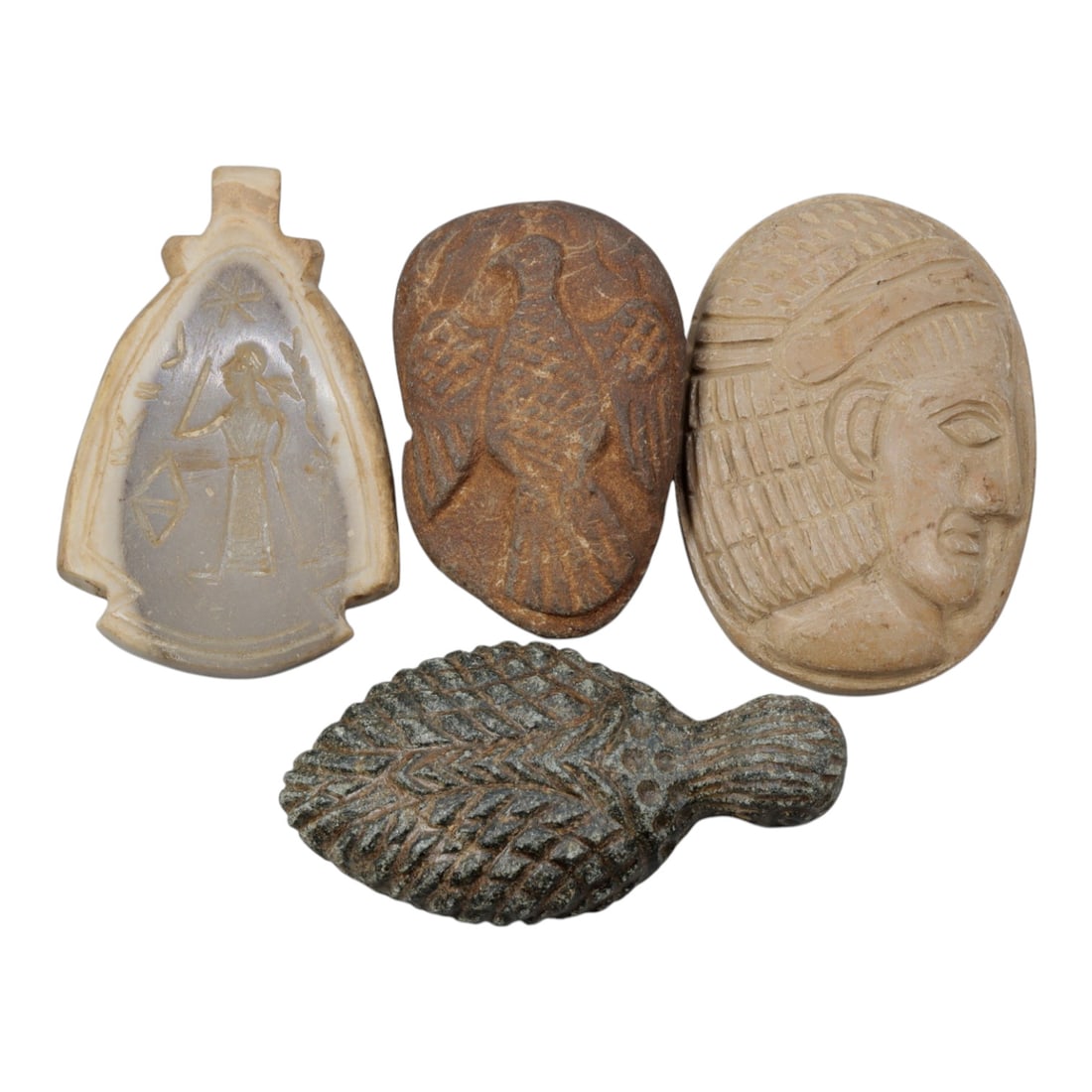 Lot of 4 Ancient Near Eastern / Coptic Egyptian Style Stone Amulets, 10WT: A curated lot of four ancient-style stone amulets, with varied forms, materials, and iconography characteristic of Near Eastern and Coptic Egyptian traditions.1 leaf-shaped grey stone amulet with inci