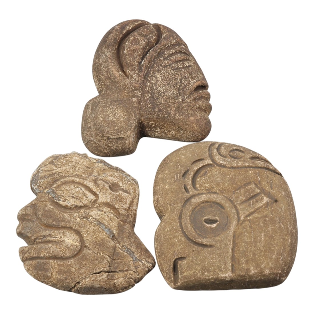 Lot of 3 Tribal Stone Carvings - Anthropomorphic Heads, 26WT: Three carved stone heads of tribal or pre-Columbian stylistic origin, each worked from a single piece of brown stone with visible natural fissures and surface weathering. The first depicts a profile h
