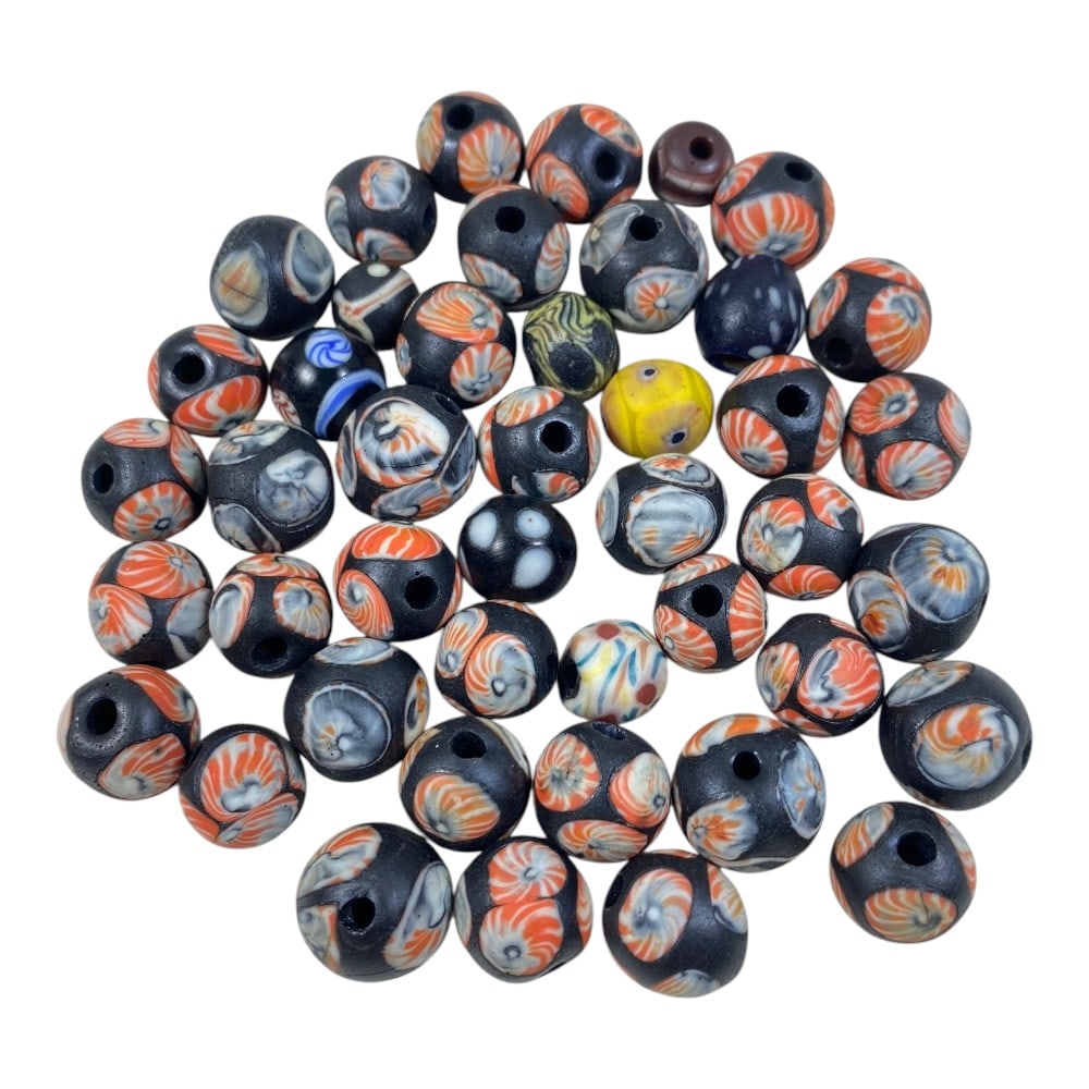 A Lot of 44 Vintage Venetian Glass Beads, 87AA: This collection features 44 vintage Venetian-style glass beads, showcasing the classic millefiori and floral inlay techniques characteristic of Murano glassmaking. The majority of beads are round, wit