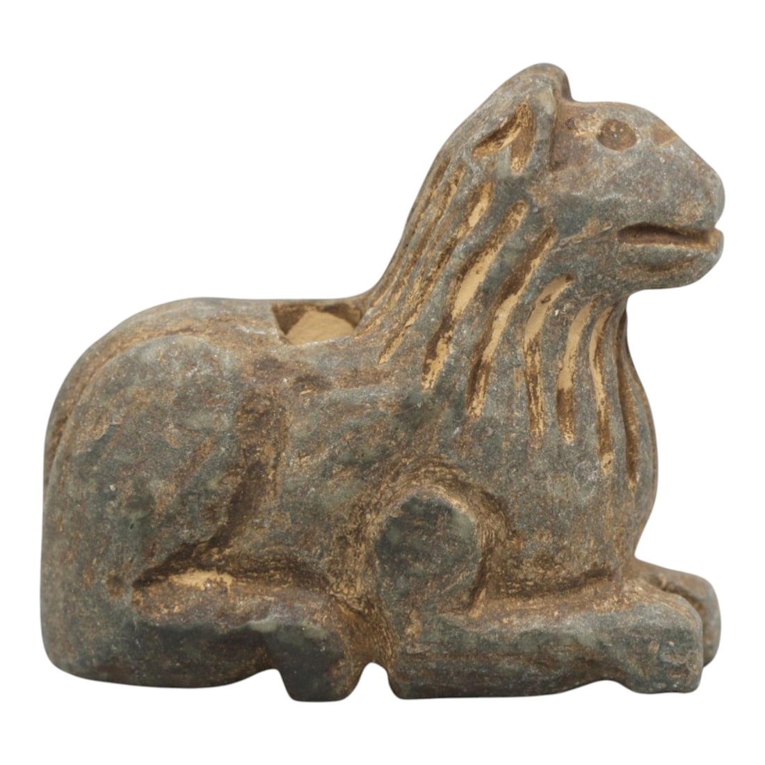Ancient Stone Feline Amulet - Near Eastern Recumbent, 45ZR: Carved from muted green-grey stone with a naturally weathered, earthy patina, executed in a stylized recumbent form characteristic of Near Eastern zoomorphic amulet craftsmanship. The figure depicts a