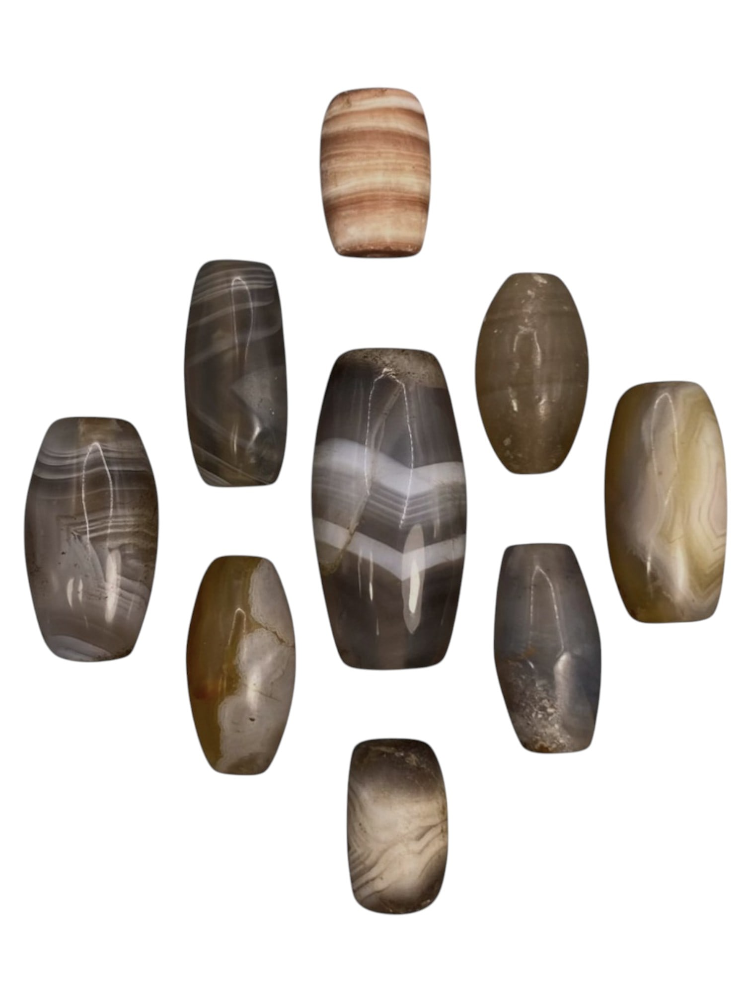 Lot of 9 Himalayan Banded Agate Beads, Ancient to Antique Period, 42WT: A group of nine beads crafted from banded agate, showcasing natural hues including translucent grey, smoky brown, milky white, and warm amber tones, with characteristic concentric, wavy, and linear ba