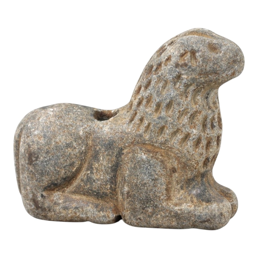 Ancient Stone Feline Amulet - Near Eastern Lion Effigy, 10AM: This amulet is carved from speckled grey stone, depicting a stylized lion in a recumbent, crouched posture. The piece features incised linear and stippled detailing defining the facial features, ears,