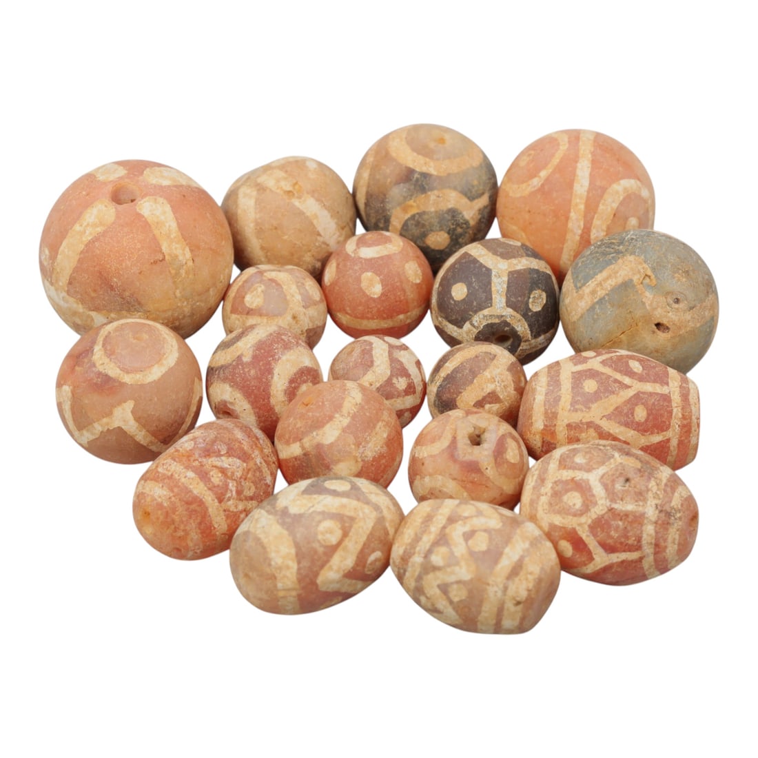 Lot of 19 Ancient Etched Carnelian Beads, Gandhara Period, 18WM: A group of 19 ancient etched carnelian beads from the Gandhara period. The beads feature spherical and oval forms, crafted from reddish-orange, greyish, and brownish carnelian. Each bead displays intr