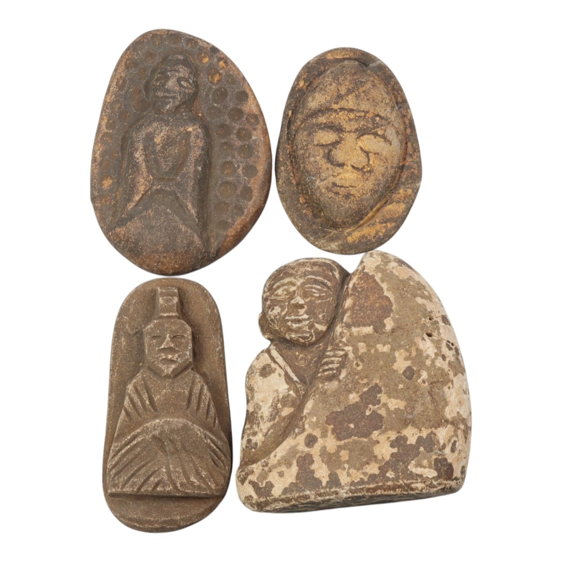 Lot of 4 Antique Japanese Edo Period Stone Buddhist Amulets, 20WT: Four carved stone Buddhist amulets of the Edo period, each depicting devotional figures or faces in relief, worked from brown and grey stone with weathered patina, surface wear, and traces of original