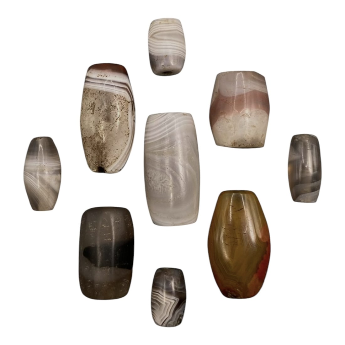Lot of 9 Himalayan Banded Agate Beads, Ancient to Antique Period, 34WT: A group of nine beads crafted from banded agate, showcasing natural hues including translucent grey, milky white, smoky brown, and amber with reddish accents, with characteristic concentric, wavy, and