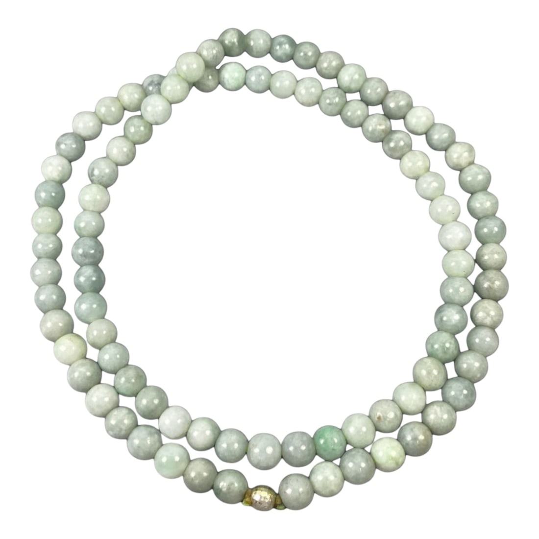A Chinese Jadeite Jade Bead Necklace, 20th Century, 67ZK: Composed of spherical beads of pale green jadeite jade with natural veining and subtle tonal variations, the necklace is strung in a continuous loop. The beads exhibit a smooth, polished surface with 