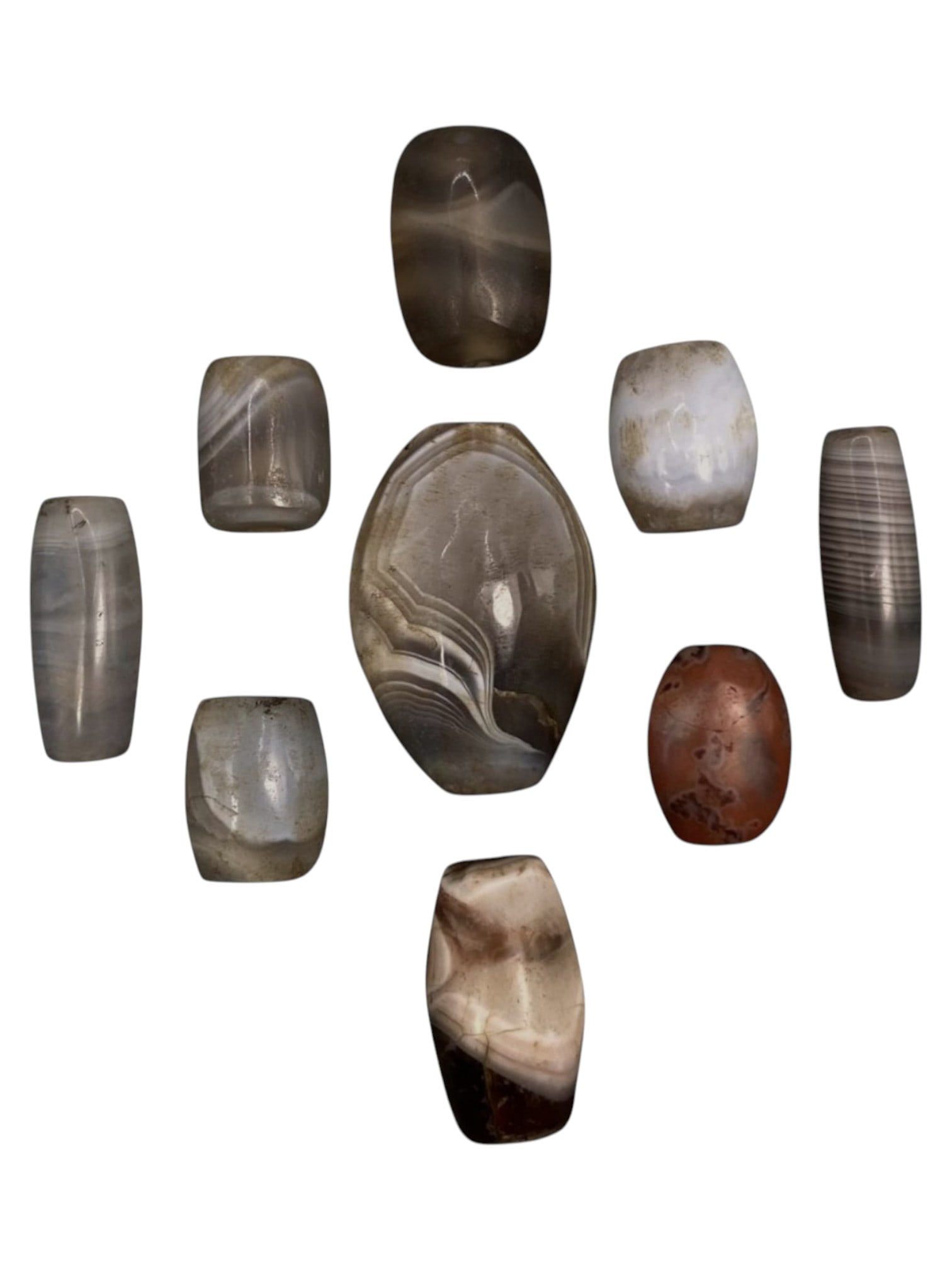 Lot of 9 Himalayan Banded Agate Beads, Ancient to Antique Period, 43WT: A group of nine beads crafted from banded agate, showcasing a diverse palette of natural tones including translucent grey, smoky brown, milky white, and rich reddish hues, with characteristic concentr