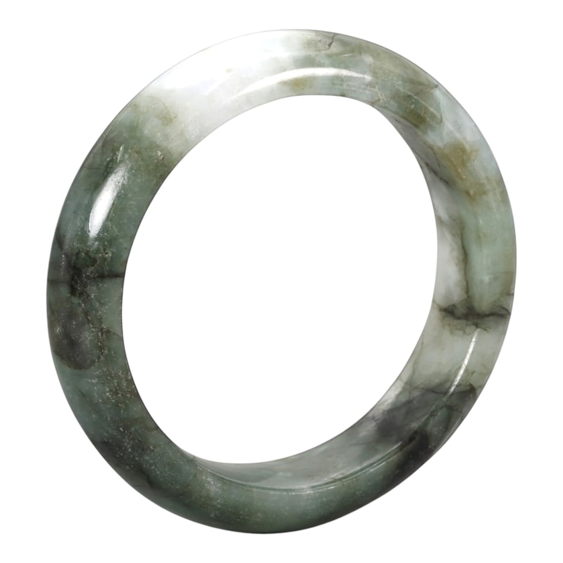 A Chinese Jadeite Jade Bangle Bracelet, 20th Century, 90ZK: Carved from jadeite jade with a pale green base and irregular dark green veining and inclusions, the bangle is formed as a continuous circular band with a rounded cross-section. The surface is smoothl