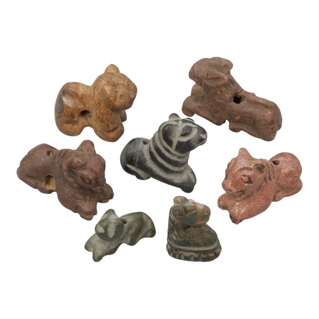 Lot of 7 Ancient Bactrian Multi-Stone Zoomorphic Amulets, 79AH: Carved from various earth-toned stones including reddish-brown, dark grey, and green varieties, the group consists of seven distinct zoomorphic amulets, ranging in size from 1.5 cm to 2.5 cm (0.59-0.9