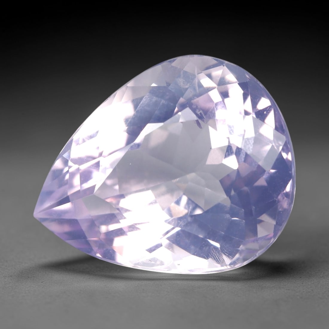 27.98 Carats Lavender Amethyst Pear - Natural Loose Gemstone, LZ59: This magnificent 27.98 carat lavender amethyst is precision-cut into a classic pear shape, measuring 23.3mm x 18.7mm x 12.9mm. It exhibits a soft, ethereal lavender hue, reminiscent of twilight skies,