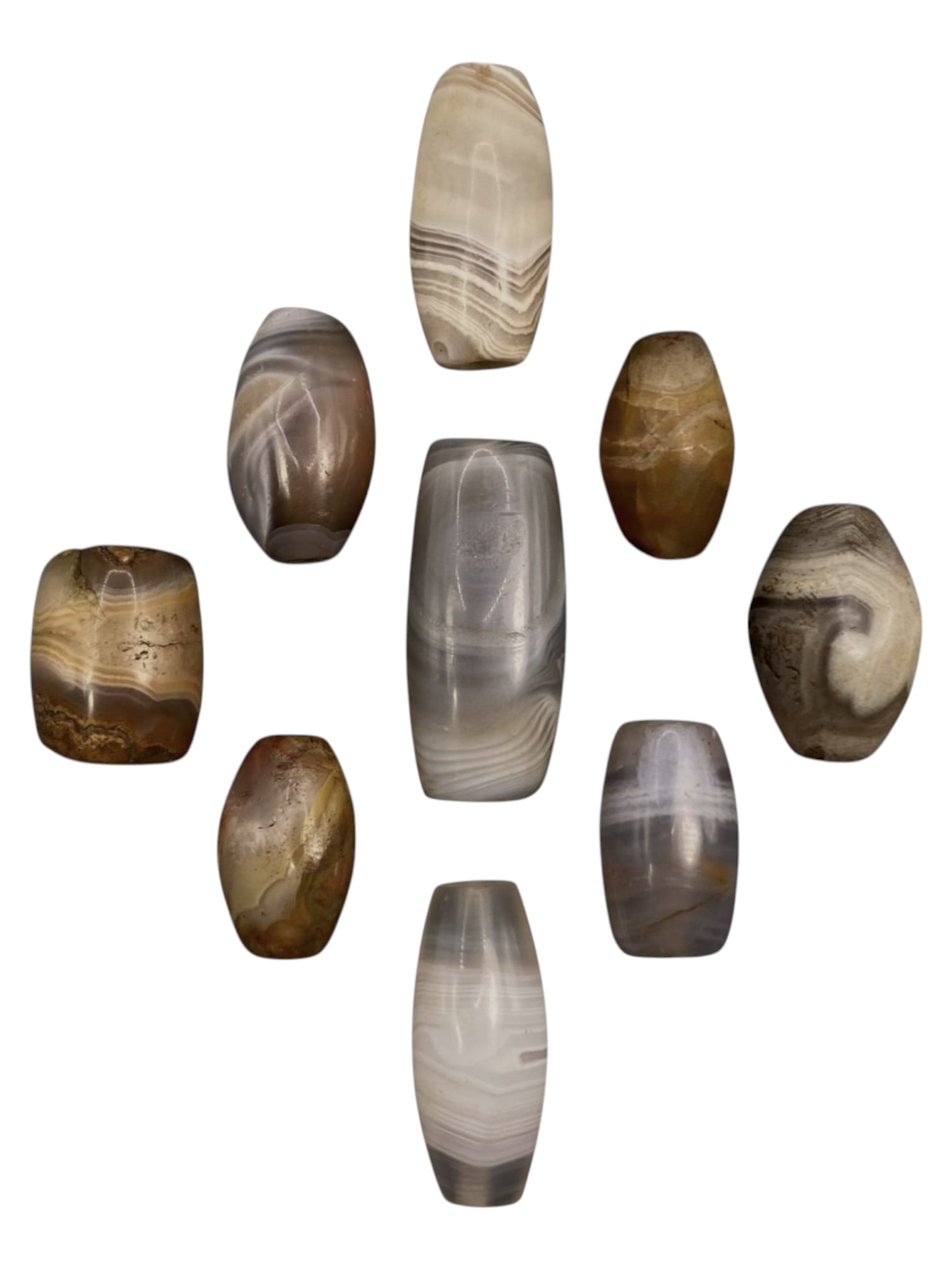 Lot of 9 Himalayan Banded Agate Beads, Ancient to Antique Period, 39WT: A group of nine beads crafted from banded agate, showcasing natural hues including translucent grey, milky white, smoky brown, and warm amber tones, with characteristic concentric, wavy, and linear ba