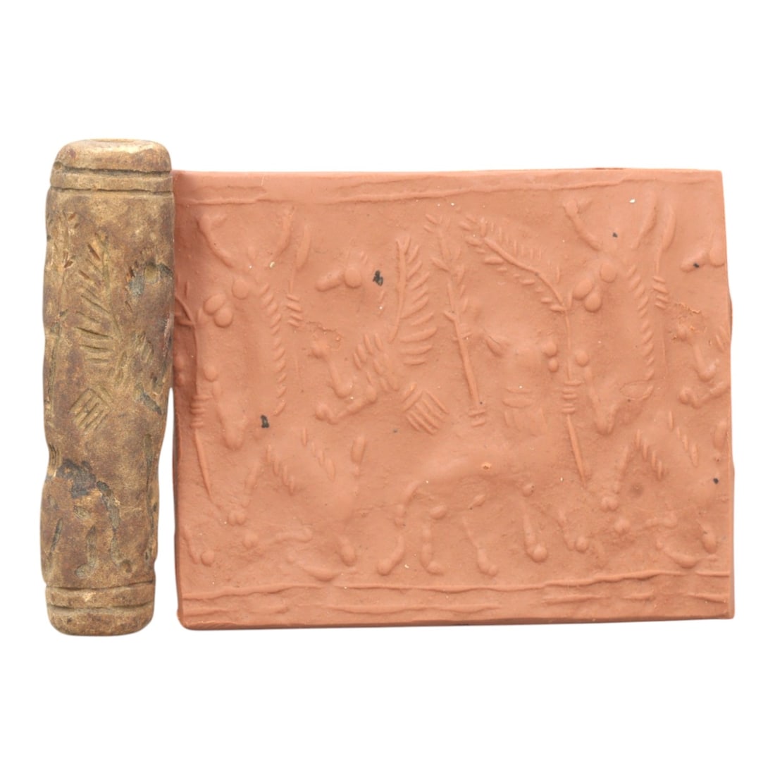 Ancient Steatite Cylinder Seal - Mesopotamian Animal Procession Scene, 88ZR: Carved from dense steatite, this ancient Mesopotamian cylinder seal features a linear relief procession of animal figures interspersed with botanical motifs, executed in the characteristic glyptic sty