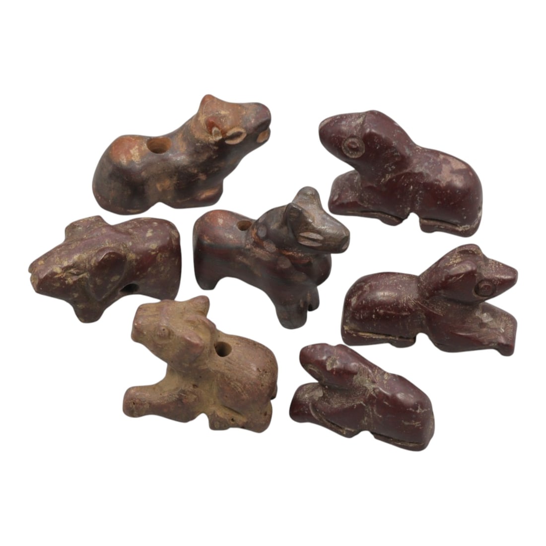 Lot of 7 Ancient Bactrian Zoomorphic Stone Amulets, Circa 3rd-2nd Millennium BCE, 75WT: Carved from dark reddish-brown stone, possibly hematite or a related ferrous stone, the group consists of seven stylized zoomorphic amulets. Each piece is rendered in a schematic, reclining or seated 