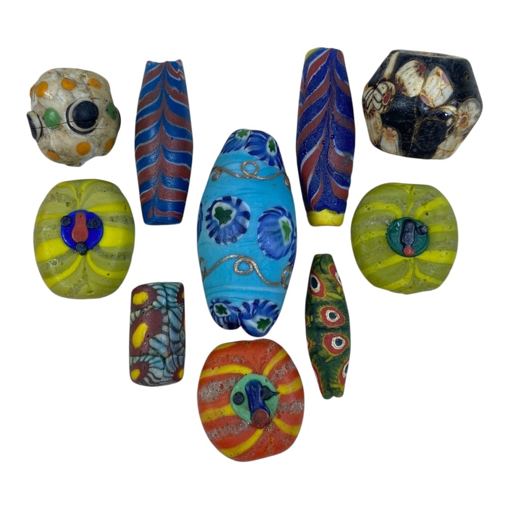 A Lot of 10 Vintage Mosaic Glass Beads, 93AA: The group comprises ten beads of varied shapes, including spherical, barrel, cylindrical, and oval forms, crafted from polychrome mosaic glass. Each bead exhibits distinct decorative patterns, includi