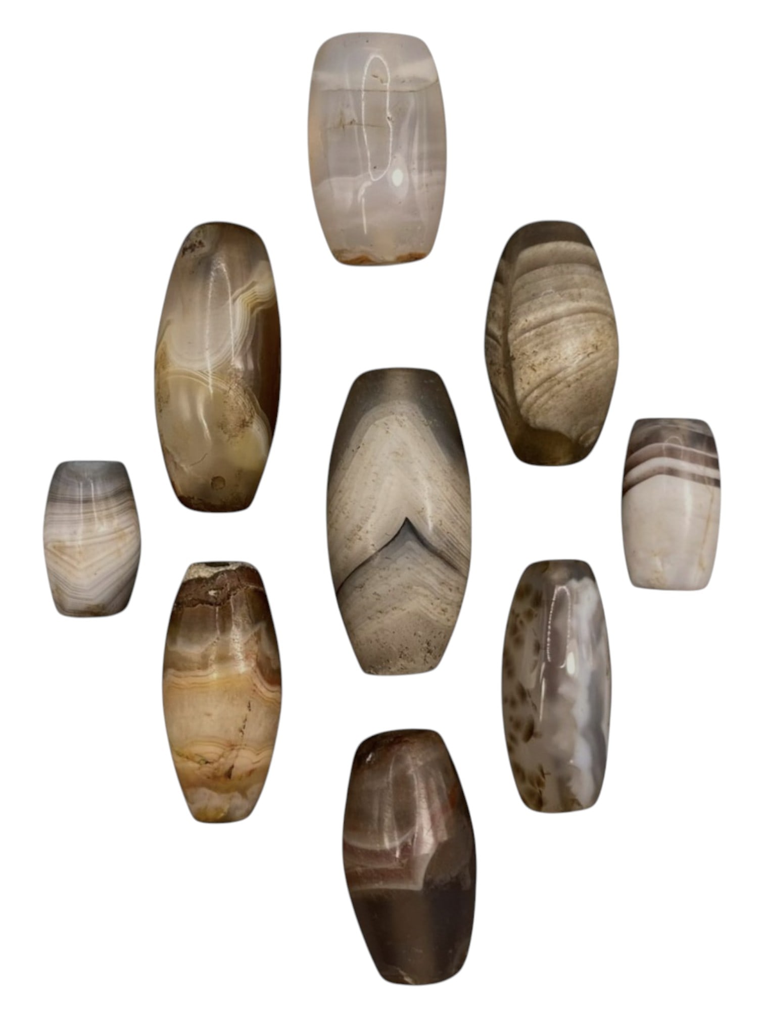 Lot of 9 Himalayan Banded Agate Beads, Ancient to Antique Period, 35WT: A group of nine beads crafted from banded agate, showcasing natural hues including translucent grey, milky white, smoky brown, and warm amber tones, with characteristic concentric, wavy, and linear ba