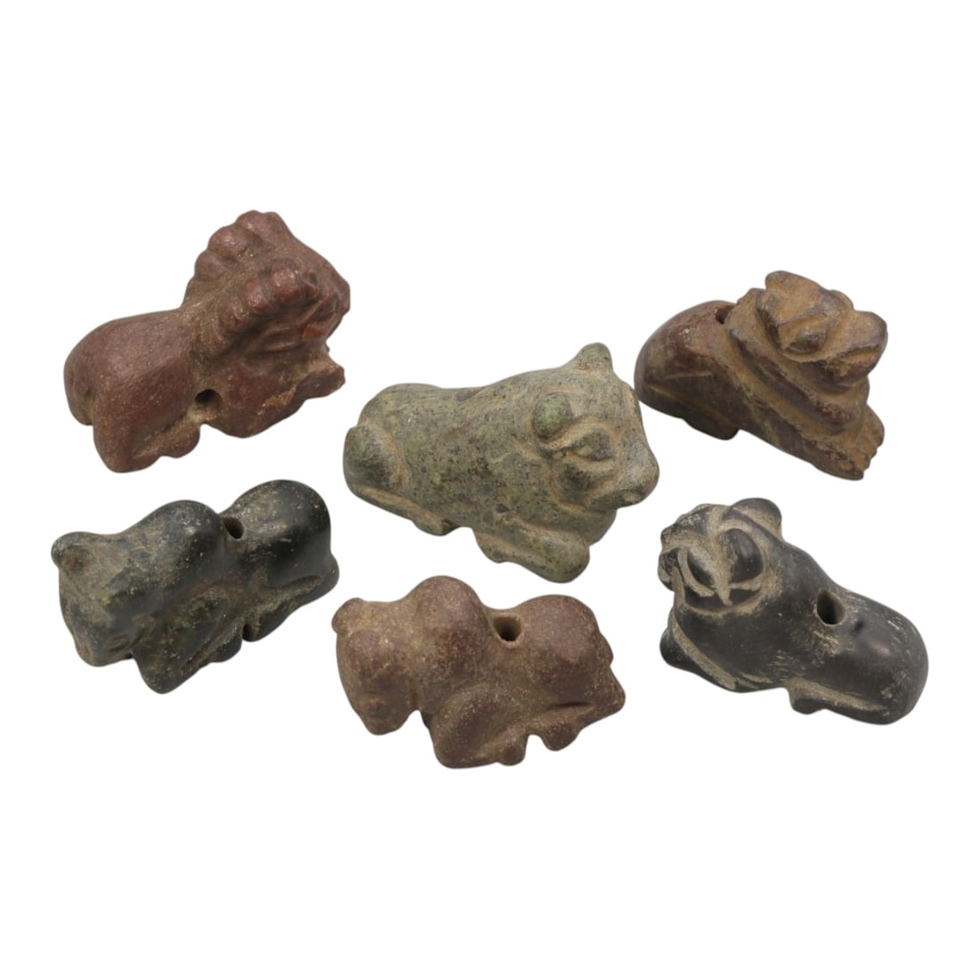Lot of 6 Ancient Bactrian Zoomorphic Stone Amulets, Circa 3rd-2nd Millennium BCE, 74WT: Carved from various coloured stones, including green, reddish-brown, and dark grey varieties, the group consists of six stylized zoomorphic amulets. Each piece is rendered in a schematic, reclining or