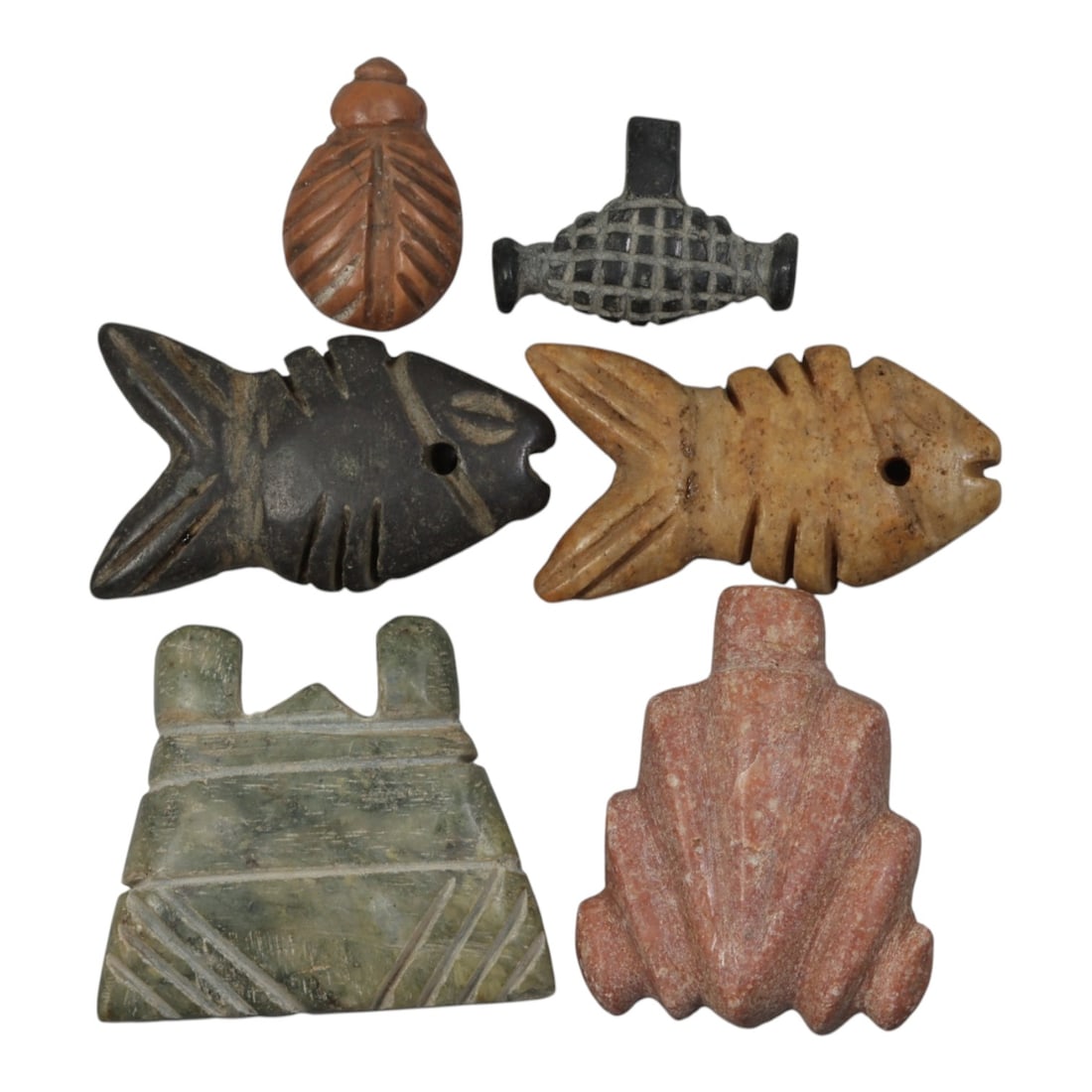 Lot of 6 Ancient Coptic Egyptian Stone Amulets, Circa Roman to Coptic Era, 83WT: Carved from various stones, including reddish-brown, black, tan, green, and pinkish varieties, the group consists of six distinct amulets. The set includes a leaf-shaped pendant with incised detailing