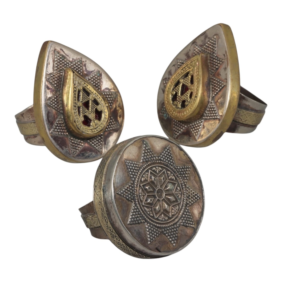 Lot of 3 Vintage North African (Berber / Tuareg) Silver-Plated Gilt Statement Rings, 38AH: A set of three vintage statement rings, crafted in silver-plated metal with gilt accents, featuring traditional North African Berber or Tuareg-inspired designs. The rings display signature motifs of t