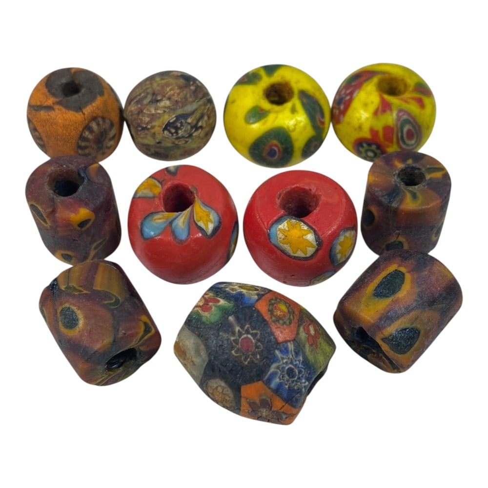 A Lot of 11 Antique/ Vintage Artisan Glass Trade Beads, 91AA: This eclectic collection features 11 handcrafted glass beads, showcasing diverse styles and techniques characteristic of historical trade bead craftsmanship. The set includes both round and cylindrica