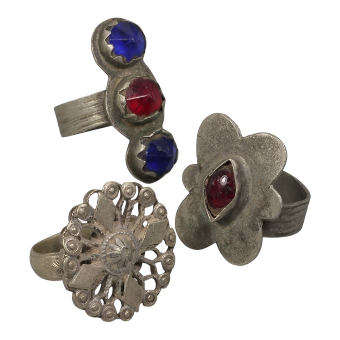 Lot of 3 Antique Central Asian Tribal Silver Statement Rings, 75AH: A set of three antique statement rings, crafted in silver with traditional tribal designs characteristic of Central Asian or Himalayan jewelry traditions. Each ring features unique handcrafted details