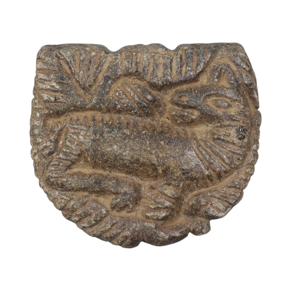 Ancient Near Eastern Schist Plaque with Recumbent Feline, Circa 1st Millennium BCE, 35AE: Carved from dark schist stone, this plaque features a recumbent feline, likely a lion or panther, in relief at the centre. The animal is depicted in profile, with incised lines defining its mane, faci