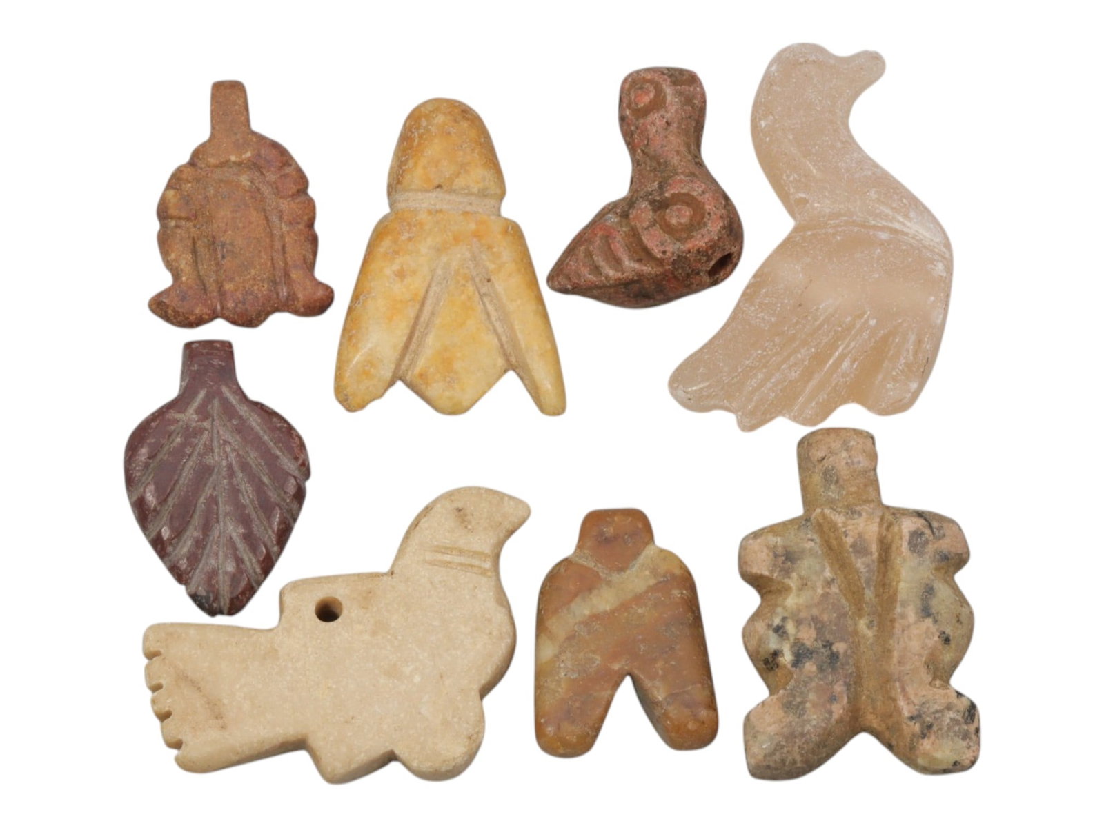 Lot of 8 Ancient Coptic Egyptian Multi-Stone Amulets, Roman to Coptic Era, 77WT: Carved from a variety of earth-toned stones, including reddish-brown, yellowish, translucent, and speckled varieties, the group consists of eight distinct amulets, ranging in size from 2 cm to 3 cm (0