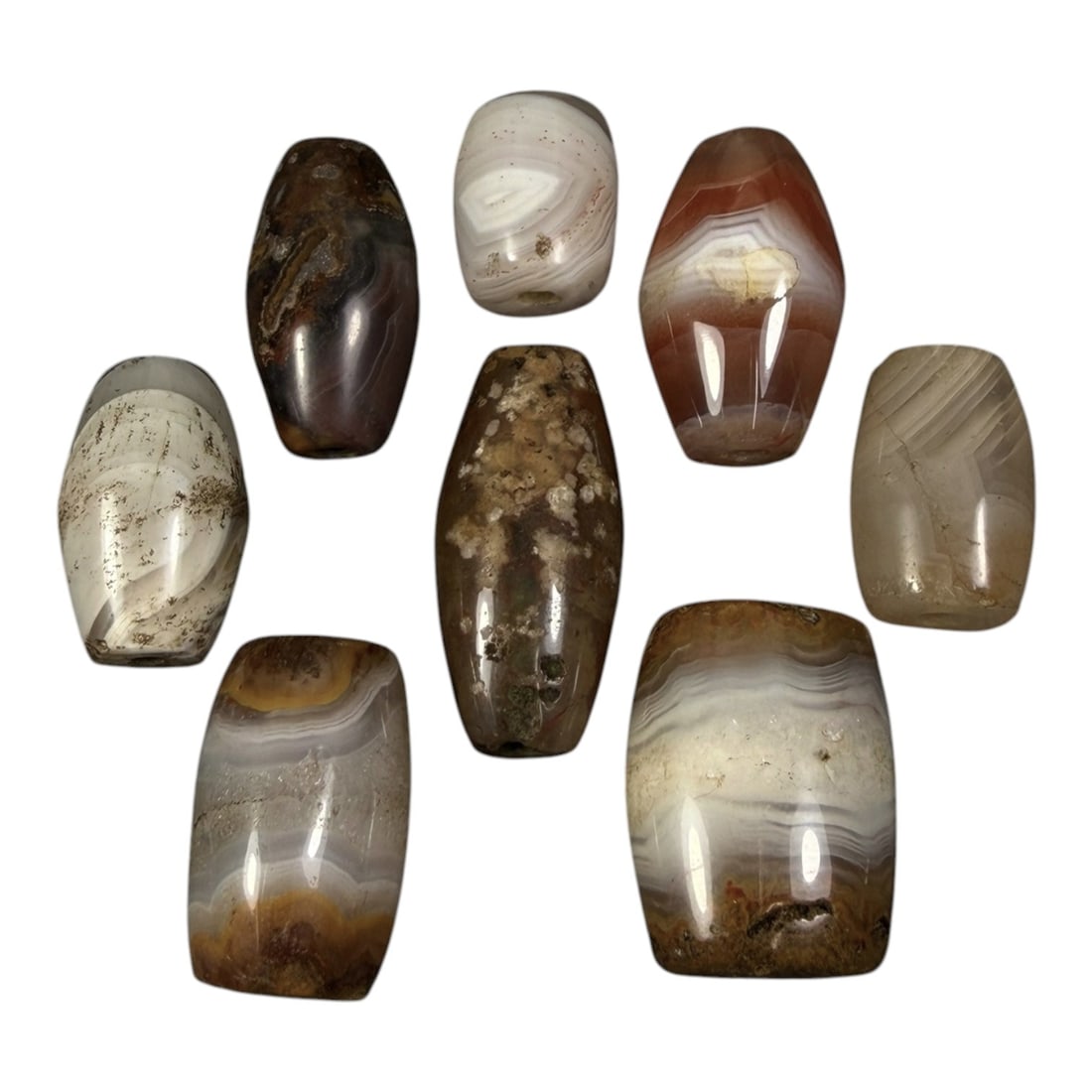 Lot of 8 Himalayan Banded Agate Beads, Ancient to Antique Period, 94AG: A group of eight beads crafted from banded agate, exhibiting natural tonal variations including translucent white, grey, reddish-brown, and multi-tonal hues, with characteristic concentric, linear, an