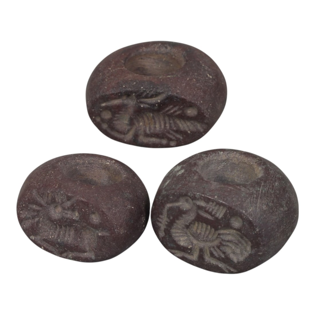 Lot of 3 Sasanian Dark Red Stone Stamp Seals, Circa 3rd-7th Century CE, 64WM: A group of three Sasanian period stamp seals carved from dark red stone, exhibiting natural patination, surface wear, and subtle weathering consistent with age. Each is of rounded, barrel form with a 