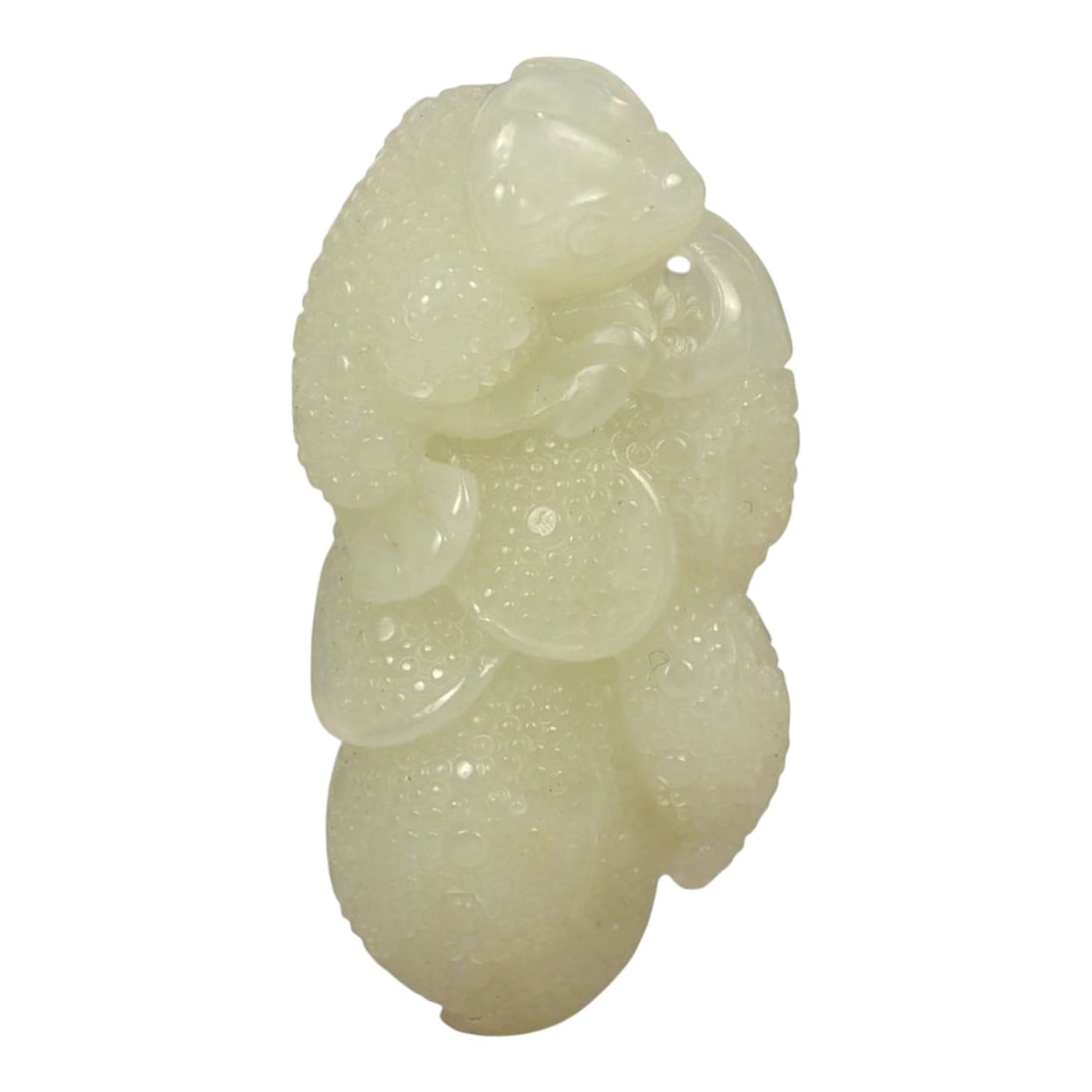 A Chinese Jade Beast and Fruit Carving, 20th Century, 78FA: Carved from pale green to light yellow jade with areas of translucency and scattered natural inclusions, the object represents a stylized beast crouched upon a fruiting form. The creature is rendered 