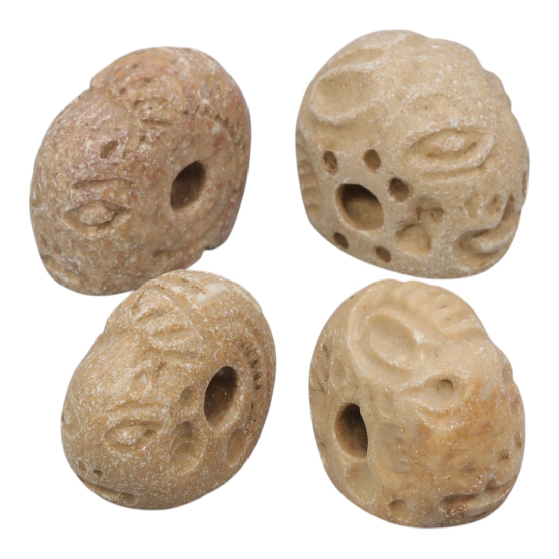 Lot of 4 Ancient Sasanian Anthropomorphic Stone Stamp Seals, 87WT: Carved from light-colored stone with natural variations in tone, the group consists of four distinct anthropomorphic stamp seals. Each piece features a rounded, bead-like form with stylized facial mot