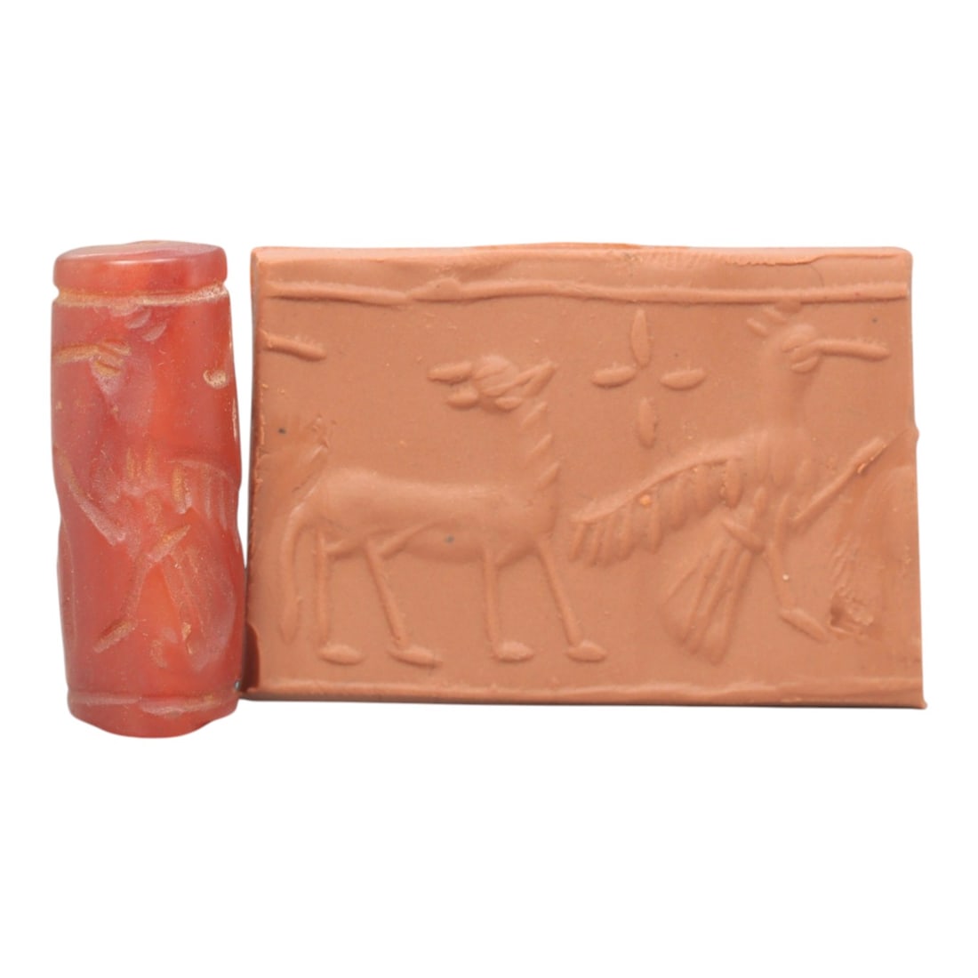 Ancient Carnelian Cylinder Seal - Mesopotamian Stag & Avian Scene, 74ZS: Carved from rich red carnelian, this ancient Mesopotamian cylinder seal features a refined linear relief composition of a standing stag and a large winged bird, separated by a floral cross symbol, exe