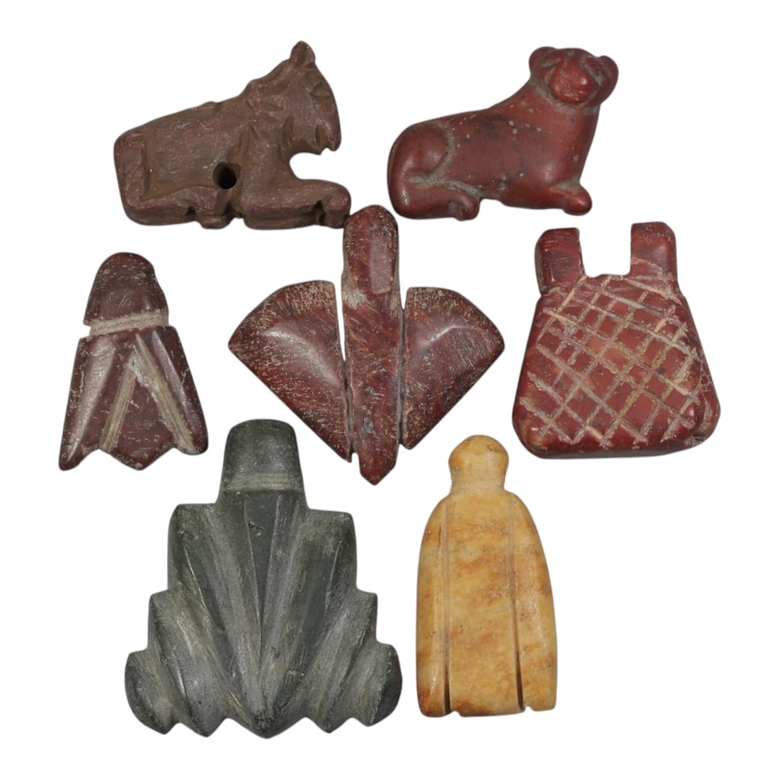 Lot of 7 Ancient Coptic Egyptian Multi-Stone Amulets, Circa Roman to Coptic Era, 96AH: Carved from various earth-toned stones including reddish-brown, dark grey, and yellowish marble varieties, the group consists of seven distinct amulets, ranging in size from 2 cm to 3.5 cm (0.79-1.38 