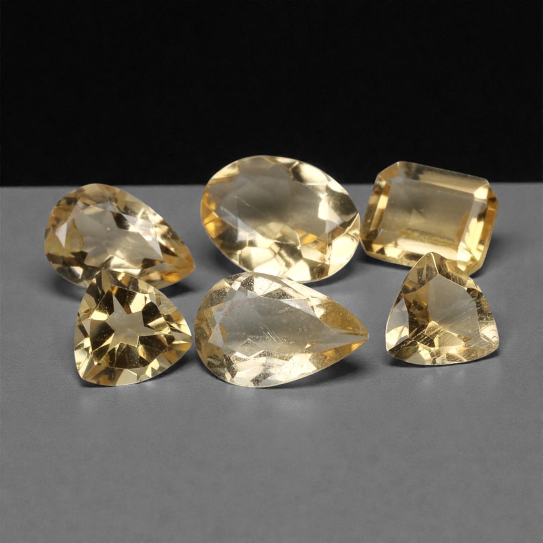 3.49 Carats Golden Yellow Citrine Parcel - Natural Brazilian Mixed Cut Stones, 29ZH: This curated parcel of citrine gems radiates a warm, luminous golden yellow hue, reminiscent of sunlit honey and liquid amber. The stones are presented in a variety of precision cuts-including pear, e