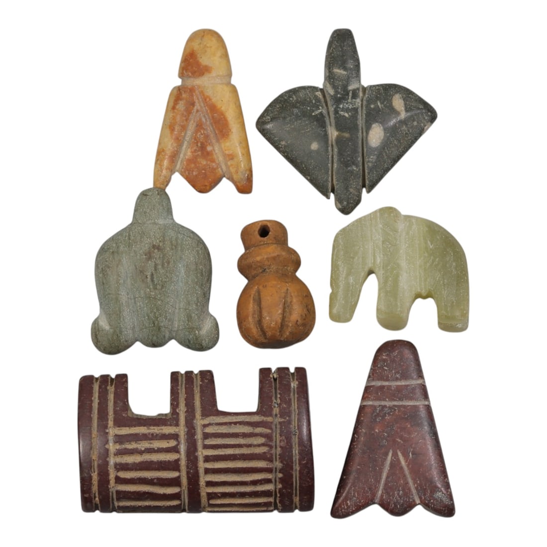 Lot of 7 Ancient Coptic Egyptian Multi-Stone Amulets, Circa Roman to Coptic Era, 98AH: Carved from various earth-toned stones including yellowish marble, dark grey, green serpentine, and reddish-brown varieties, the group consists of seven distinct amulets, ranging in size from 2 cm to 
