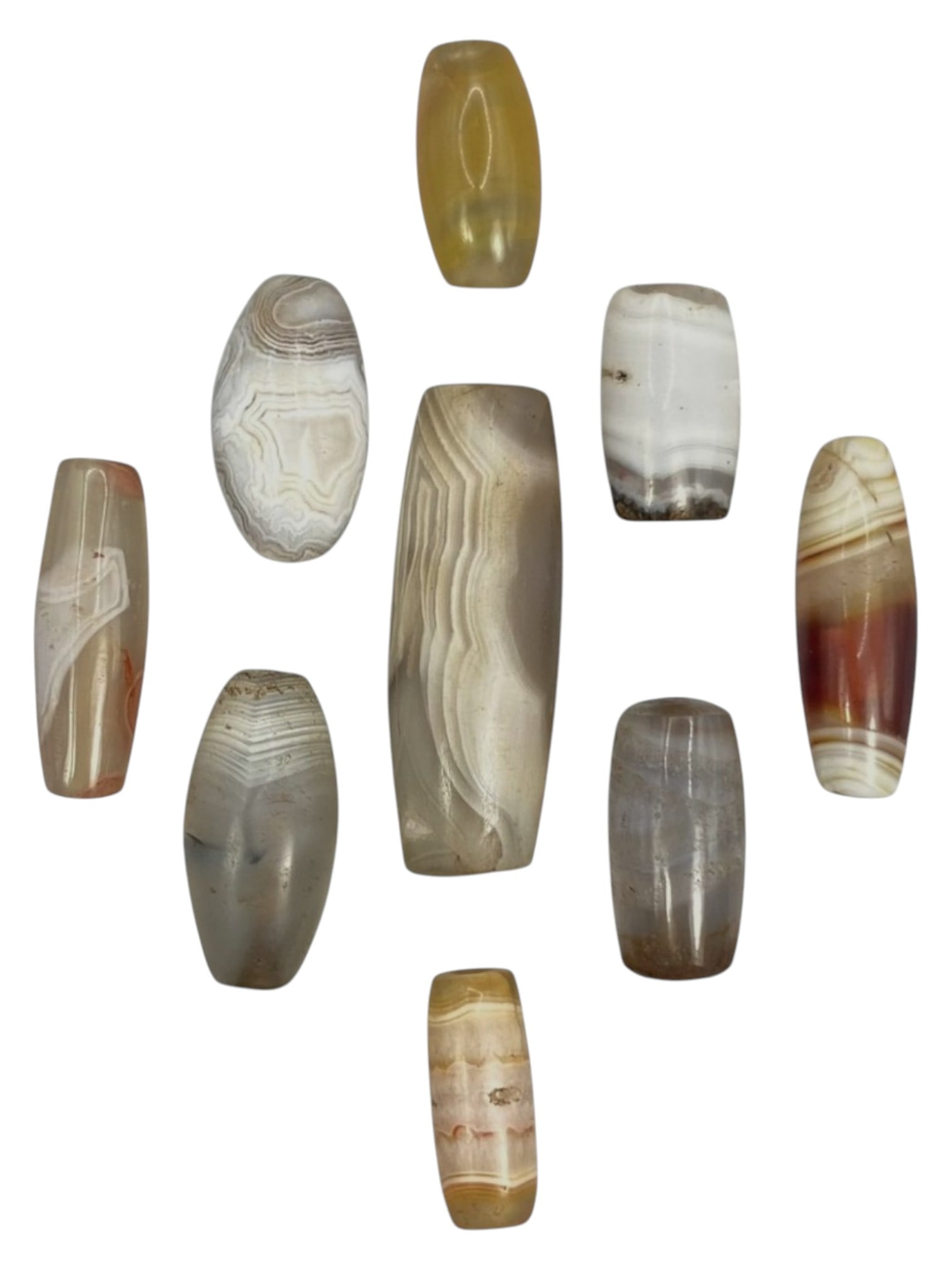 Lot of 9 Himalayan Banded Agate Beads, Ancient to Antique Period, 46WT: A group of nine beads crafted from banded agate, showcasing natural hues including translucent grey, milky white, amber, and multi-tonal reddish-brown striations, with characteristic concentric, wavy,