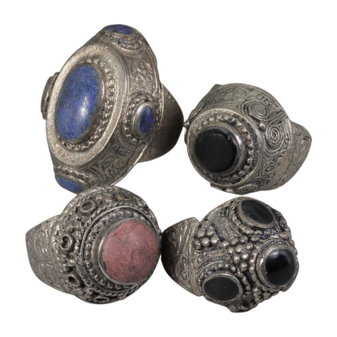 Lot of 4 Vintage Central Asian Tribal Silver-Plated Statement Rings, 61AH: A set of four vintage statement rings, crafted in silver-plated metal with intricate tribal-style ornamentation characteristic of Central Asian or Himalayan jewelry traditions. Each ring features dist