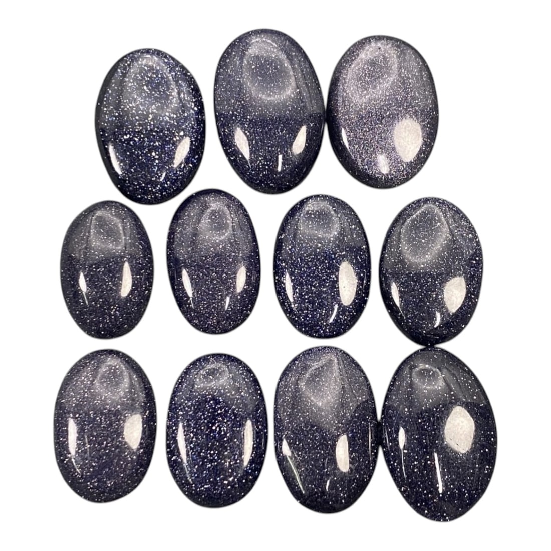 109.08 Carats Midnight Blue Goldstone Cabochon Parcel 1.7-2cm, 74ZJ: This luminous parcel of midnight blue goldstone cabochons shimmers with a celestial sparkle, evoking the quiet magic of a starry night sky. Each oval cabochon, sized between 1.7 and 2 centimeters, glo