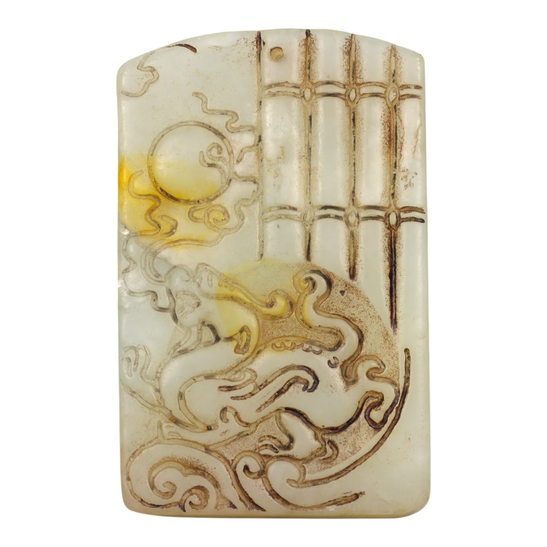 A Chinese Jade Dragon and Sun Relief Plaque, 20th Century, 45YA: Carved from pale white jade with areas of warm russet and yellowish staining following the natural inclusions of the stone, the plaque is rectangular in form with a flat reverse and softly rounded edg