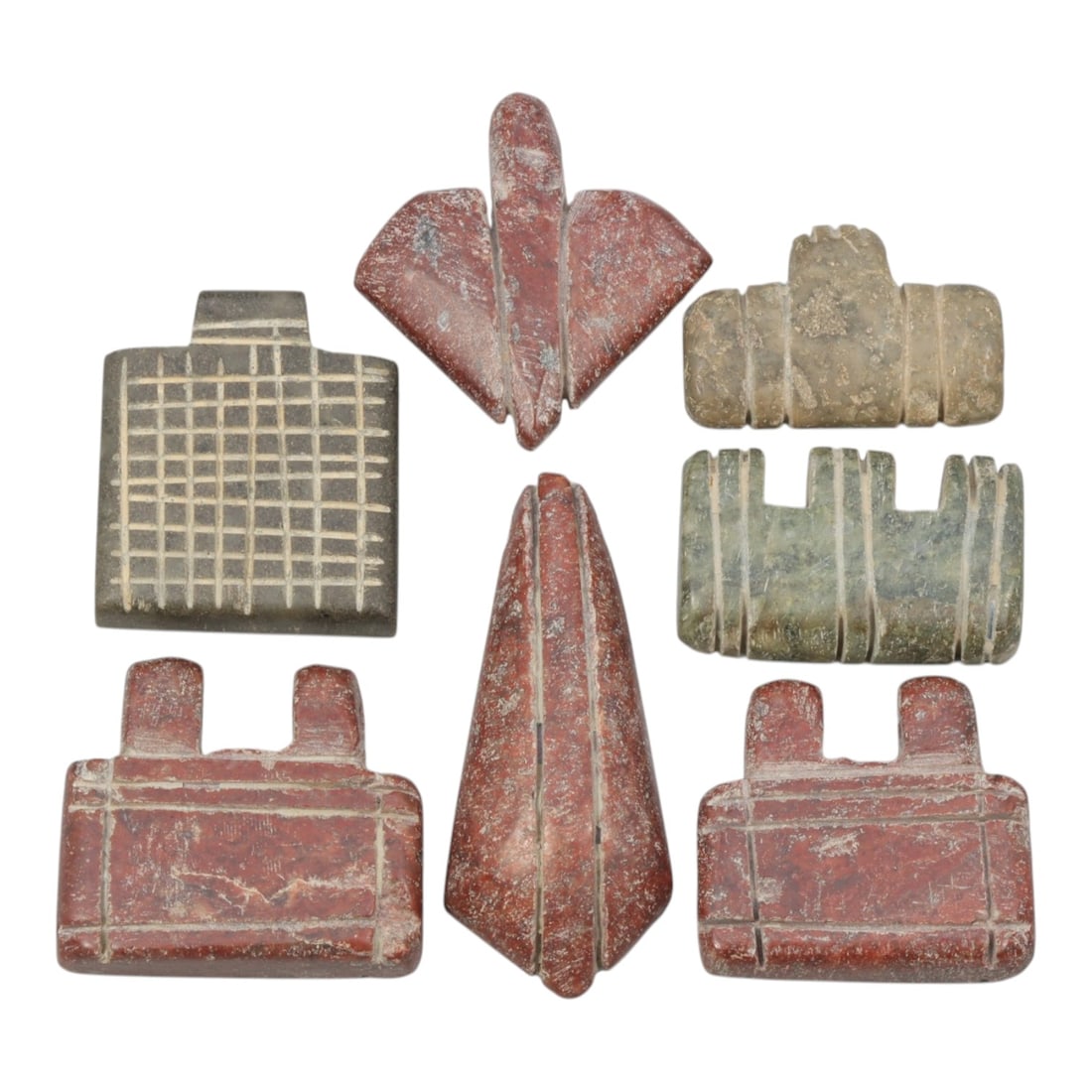 Lot of 7 Ancient Coptic Egyptian Multi-Stone Amulets, Circa Roman to Coptic Era, 77AH: Carved from various earth-toned stones including grey, reddish-brown, and greenish varieties, the group consists of seven distinct amulets, ranging in size from 2.5 cm to 4 cm (0.98-1.57 in.). The set