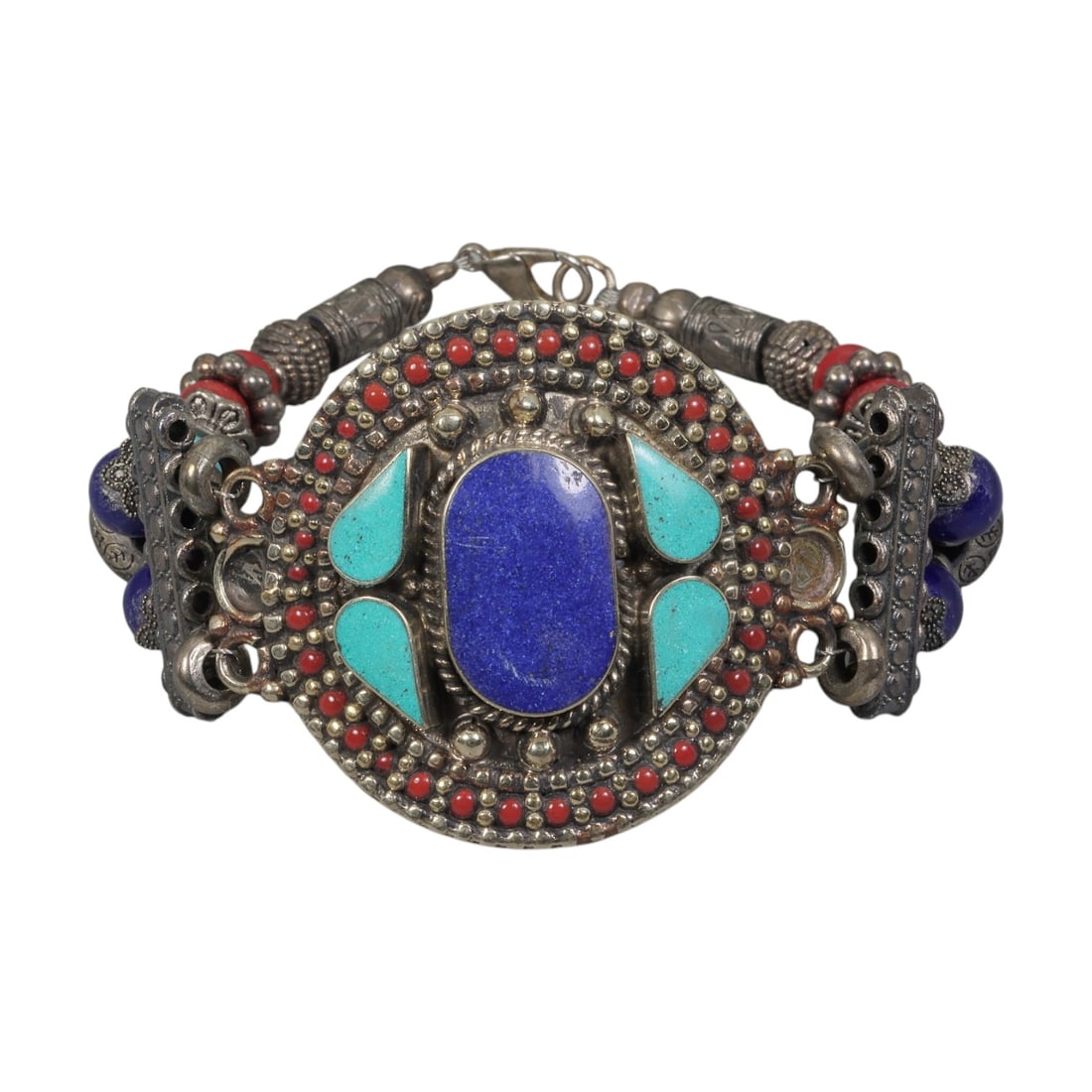 A Vintage Himalayan Silver-Plated Multi-Stone Inlay Bracelet, 5AH: A handcrafted vintage bracelet, measuring approximately 7 cm in width, showcasing traditional Himalayan jewelry design. The piece features a silver-plated metal base with a large central oval lapis la