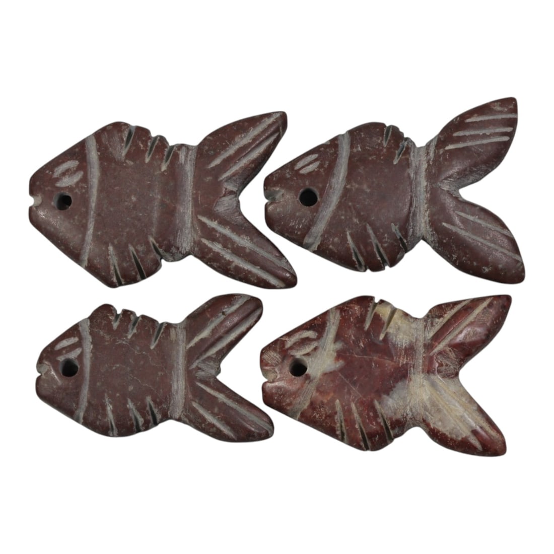 Lot of 4 Ancient Coptic Egyptian Stone Fish Amulets, Circa Roman to Coptic Era, 87WP: Carved from reddish-brown stone, the group consists of four flat fish-shaped amulets. Each piece features simplified incised detailing, including stylized eyes, fin lines, and segmented body patterns.
