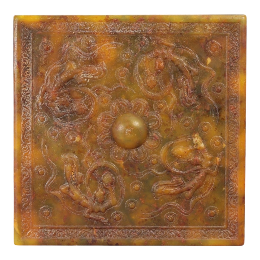 A Chinese Jade Relief Plaque, 20th Century, 50FD: Carved from mottled yellow-brown and olive-toned jade with areas of natural translucency and darker inclusions. The plaque is square in form and worked in shallow to moderate relief on one face, frame