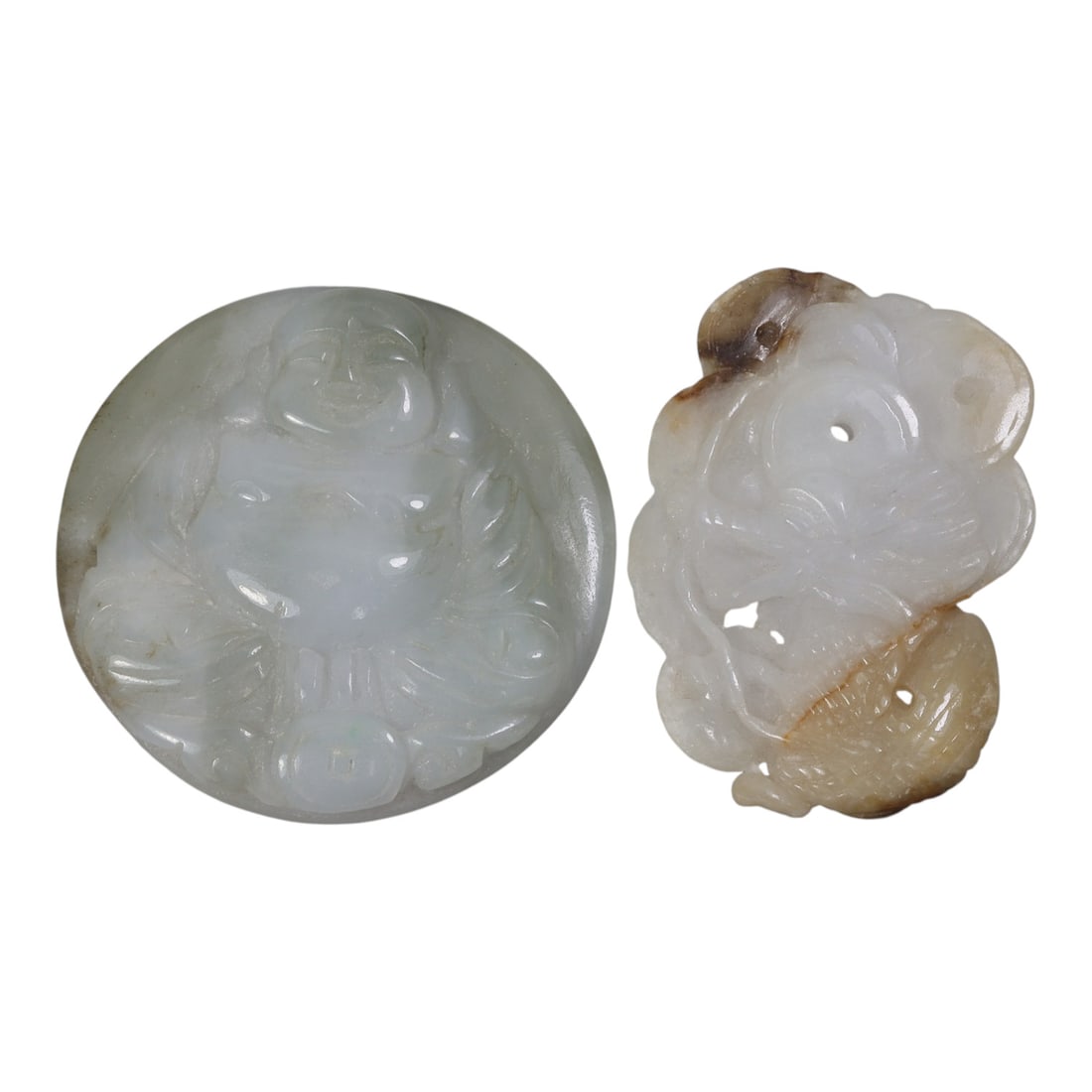 Lot of 2 Antique Oriental Chinese Jadeite Jade Carved Pendants, 45AG: Carved from pale jadeite jade with natural tonal variations and brown inclusions, the two pendants feature distinct motifs. The circular pendant depicts a seated Budai with a rounded belly, smiling ex